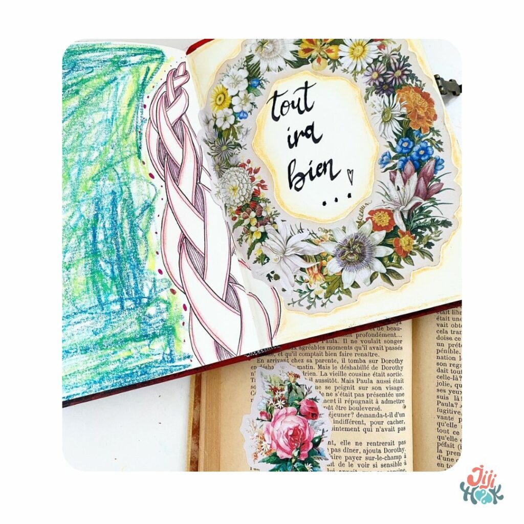 un carnet de dessin ouvert sur une page avec un dessin de fleurs et "tout ira bien" posé sur un livre, motif zentangle et émotions