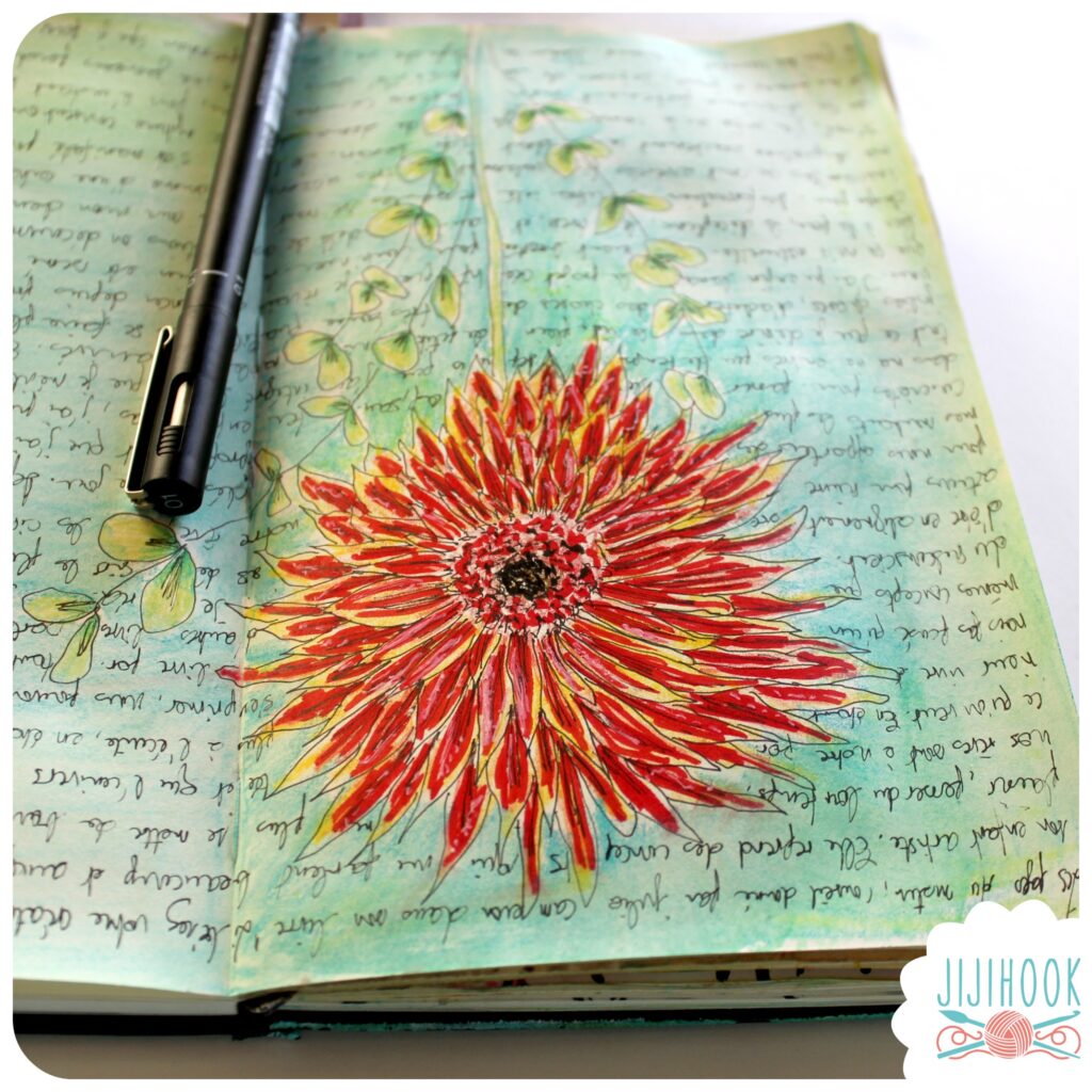 artjournal, fleur rouge avec feuilles vertes dessinée au milieu d'un carnet
